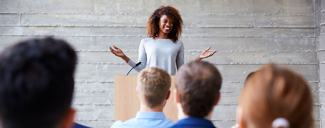 speakers talking in front of audience