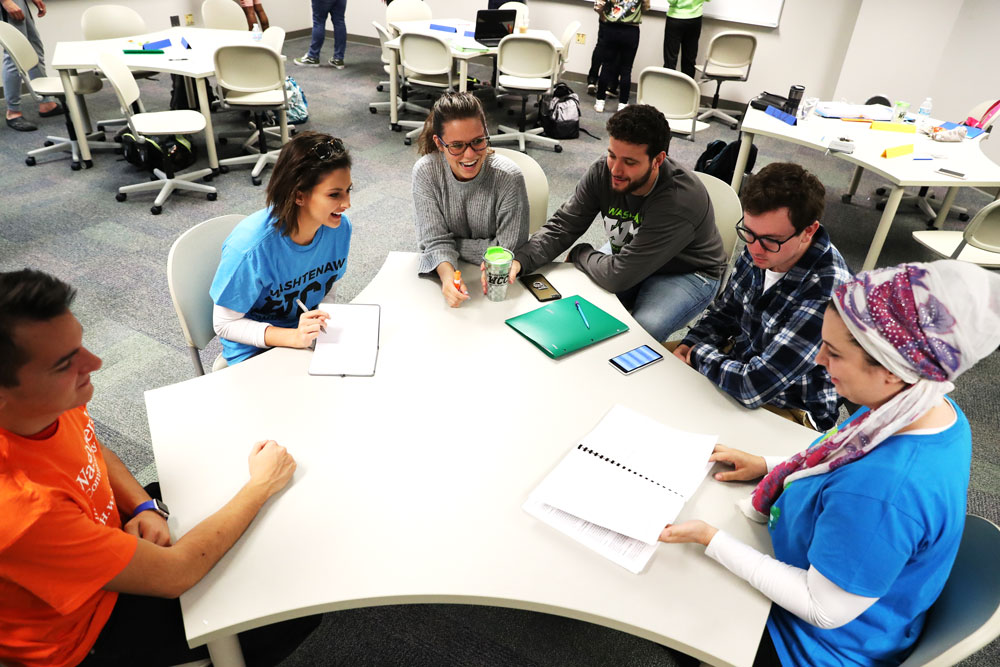 business students working around a table