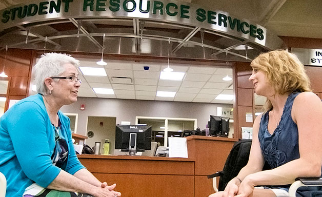 Liz Orbits talking with a student at the Student Resource Center